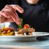 Chef finishing and garnishing food he prepared